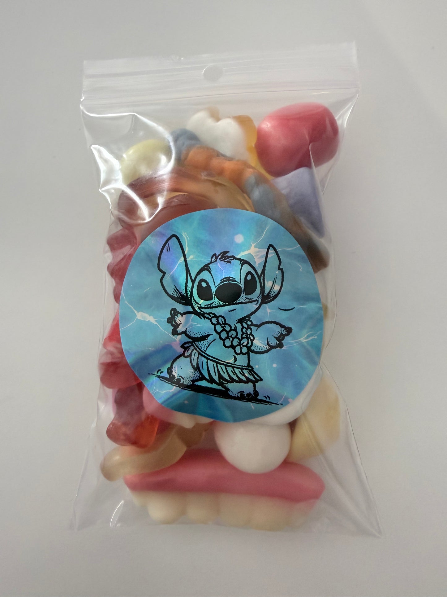 Sachet stitch bleu collier fleur 100 gr bonbons mélange